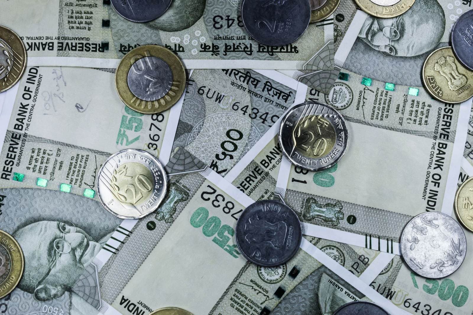 Indian rupee coins lying on five-hundred-rupee notes